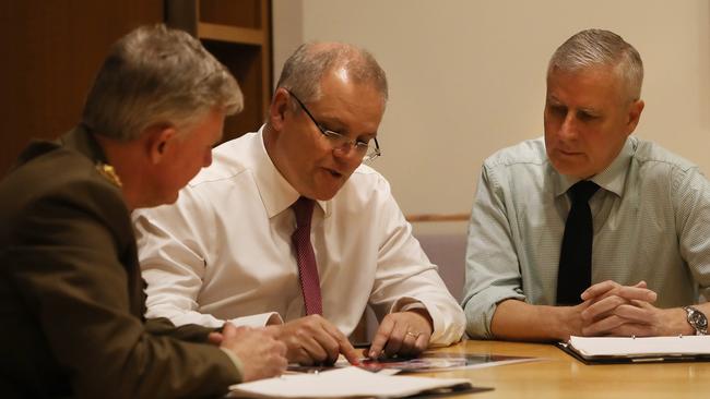 National Drought co-ordinator Major General Stephan Day meets with PM Scott Morrison and Deputy PM Michael McCormack at Parliament House on Saturday. Picture: Kym Smith