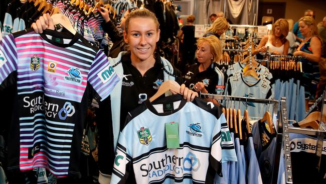 Sales assistant Elana White in the Cronulla Sharks pop up shop which is selling club merchandise in the the Cronulla Sharks club . Picture : Gregg Porteous