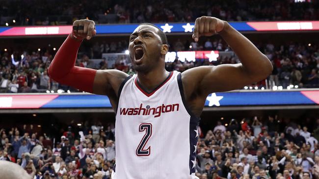 Washington Wizards guard John Wall celebrates as he stands on the scorer's table after Game 6.