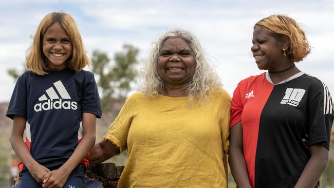 Assistant principal at the independent Yipirinya School in Alice Springs, Bess Nungarrayi Price, with students Kalisha Charles, left, and Martina Rubuntja. Picture: Liam Mendes