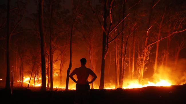 A local surveys the remains of the fire on the road to Wytaliba on Saturday. Picture: Lyndon Mechielsen