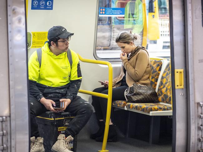 People do not wear masks on trains in Melbourne. Picture: Jake Nowakowski.