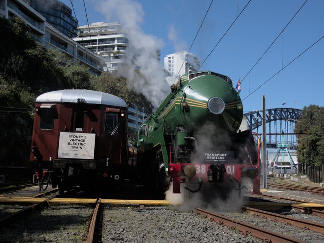 The most famous heritage steam locomotive in NSW, 3801 crosses the Sydney Harbour Bridge for the first time ever and then parks beside and original Sydney "Red Rattler" electric passenger train at Lavender Bay. Picture: Supplied