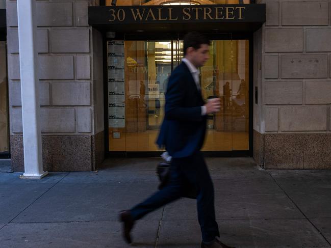 NEW YORK, NEW YORK - NOVEMBER 12: People walk along Wall Street by the New York Stock Exchange (NYSE) on November 12, 2024 in New York City. After closing at record highs yesterday, the Dow was down slightly in morning trading.   Spencer Platt/Getty Images/AFP (Photo by SPENCER PLATT / GETTY IMAGES NORTH AMERICA / Getty Images via AFP)