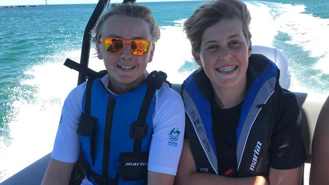 SA Police Water Operations boat bring Lachlan and Toby Sutton into shore after their brave rescue. Picture: SLSSA