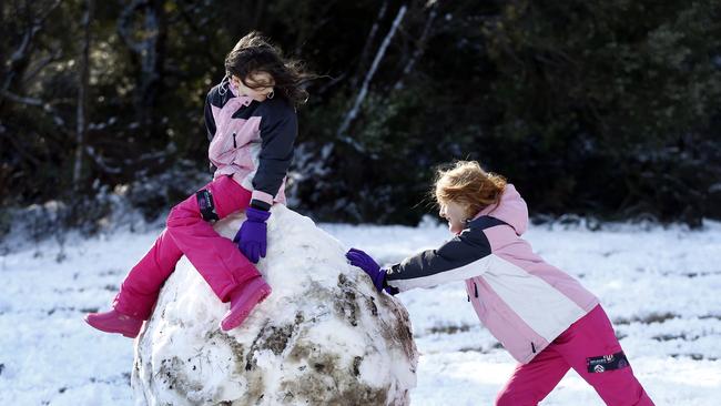 Snow fall in Hobart. mount wellington . picture of people at the top of Strickland ave sisters from left, Ashlin and Alicia Allingham from Midway Point rolling snow balls