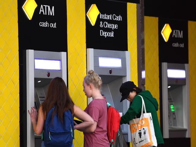 Customers use a Commonwealth Bank (CBA) ATM in Brisbane, Thursday, August 3, 2017. The Commonwealth Bank has been accused of a systemic failure to comply with anti-money laundering and counter-terrorism financing laws. The federal government's financial intelligence unit AUSTRAC on Thursday launched civil penalty proceedings in the Federal Court, accusing the lender of more than 53,700 contraventions of law. (AAP Image/Dan Peled) NO ARCHIVING