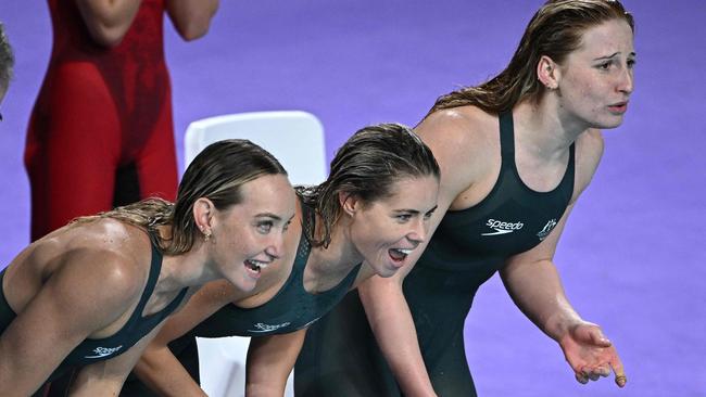 Madison Wilson, Kiah Melverton and Mollie O'Callaghan cheer on Ariarne Titmus as she brought the Aussies home for a world record.