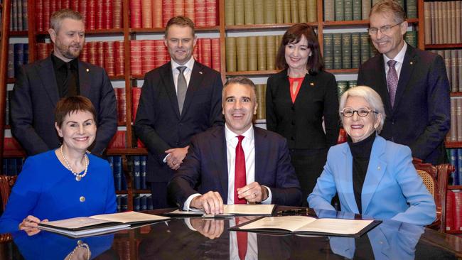 Adelaide and UniSA officials on July 2 ink a historic deal to merge. Front L to R Chancellor of the University of SA Pauline Carr, Premier Peter Malinauskas, Chancellor of the University of Adelaide Catherine Branson. Back L to R Uni SA Vice Chancellor Professor David Lloyd, Treasurer Stephen Mullighan, Deputy Premier Susan Close, University of Adelaide Vice Chancellor Professor Peter Hoj. Picture: Emma Brasier