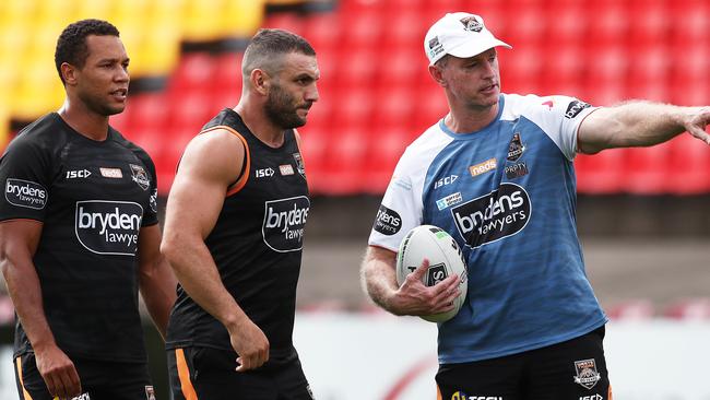 Wests Tigers coach Michael Maguire directs Robbie Farah and Moses Mbye at training. Picture. Phil Hillyard