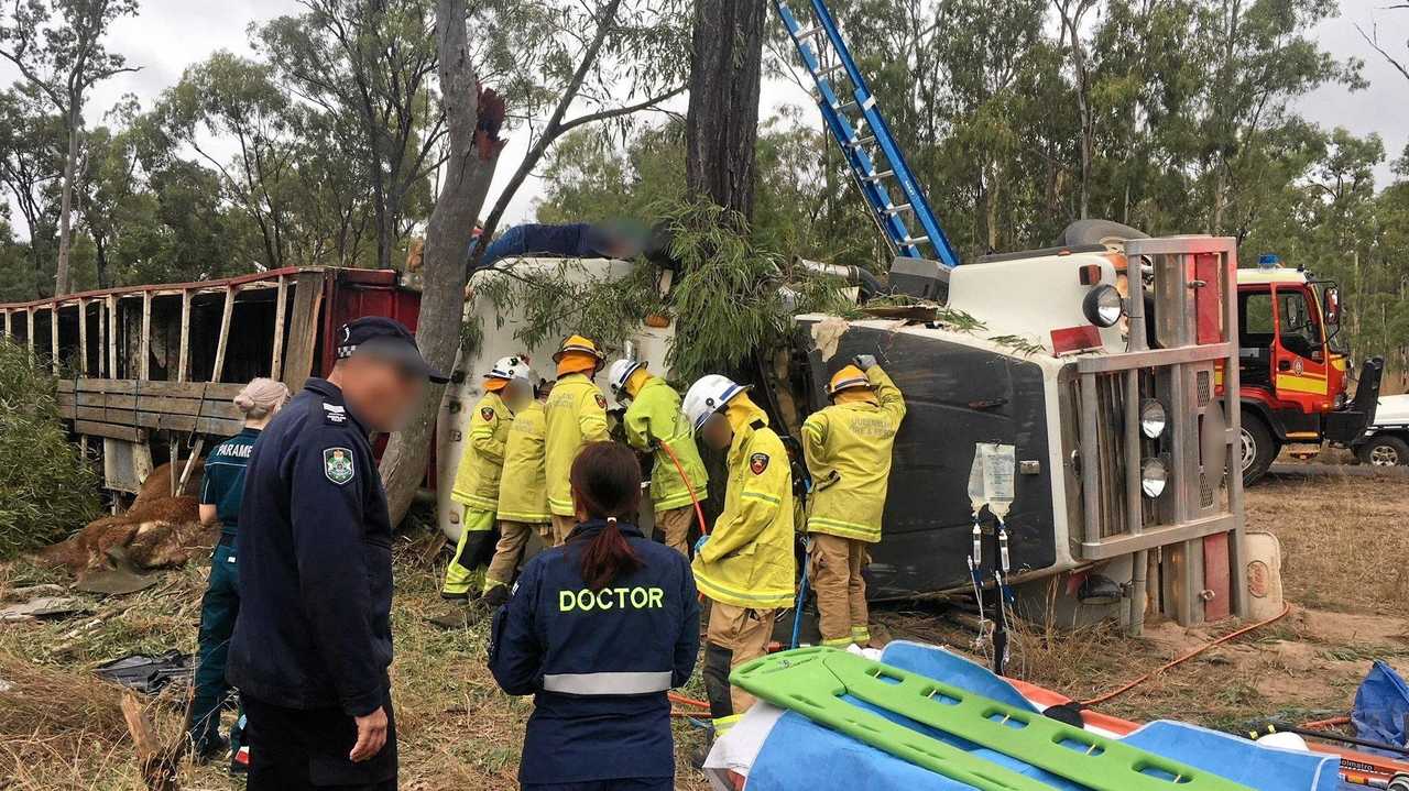 ON SCENE: Crews work to free the trapped driver from his cattle truck. Picture: Contributed