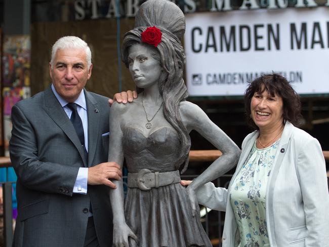 Family support ... Mitch Winehouse and Janis Winehouse pose for a picture with a statue of their late daughter. Picture: Tim Ireland/AP