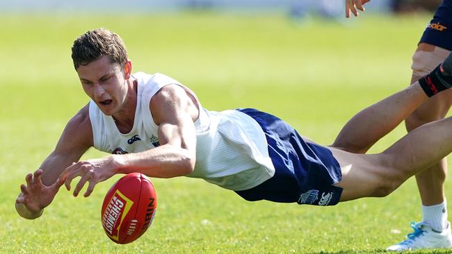 Charlie Comben dives for a mark at North Melbourne training.