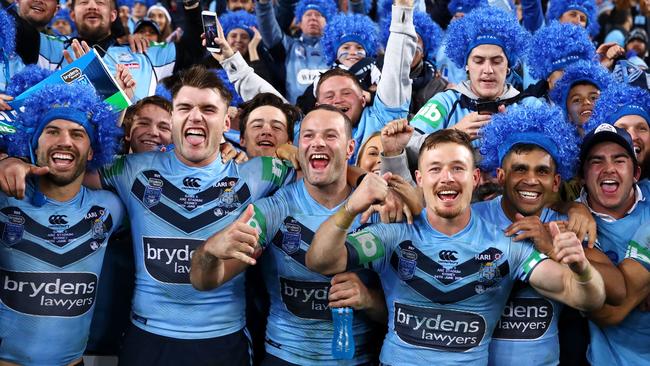 SYDNEY, AUSTRALIA — JUNE 24: James Tedesco, Angus Crichton, Boyd Cordner Damien Cook and Tyrone Peachey of the Blues celebrate with the crowd after victory in game two of the State of Origin series between the New South Wales Blues and the Queensland Maroons at ANZ Stadium on June 24, 2018 in Sydney, Australia. (Photo by Mark Kolbe/Getty Images)