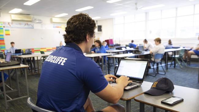 Redcliffe State High School teacher Jack Griffith delivering online teaching meanwhile looking after kids in classroom. PHOTO: AAP/Attila Csaszar