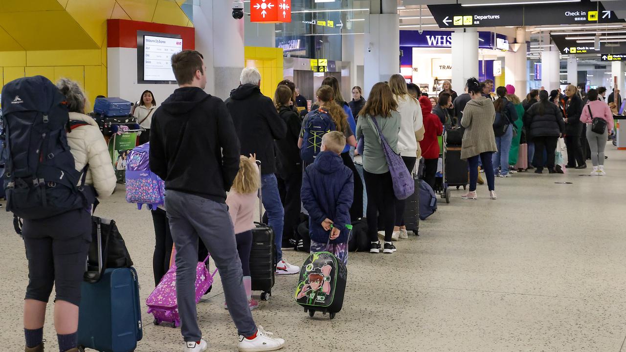 Passengers queue at the Jetstar terminal at Melbourne Airport in the aftermath of the IT outage, which caused mass flight cancellations. Picture: Ian Currie