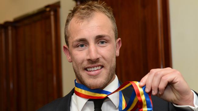 Matt Thomas with his Magarey Medal in 2013.