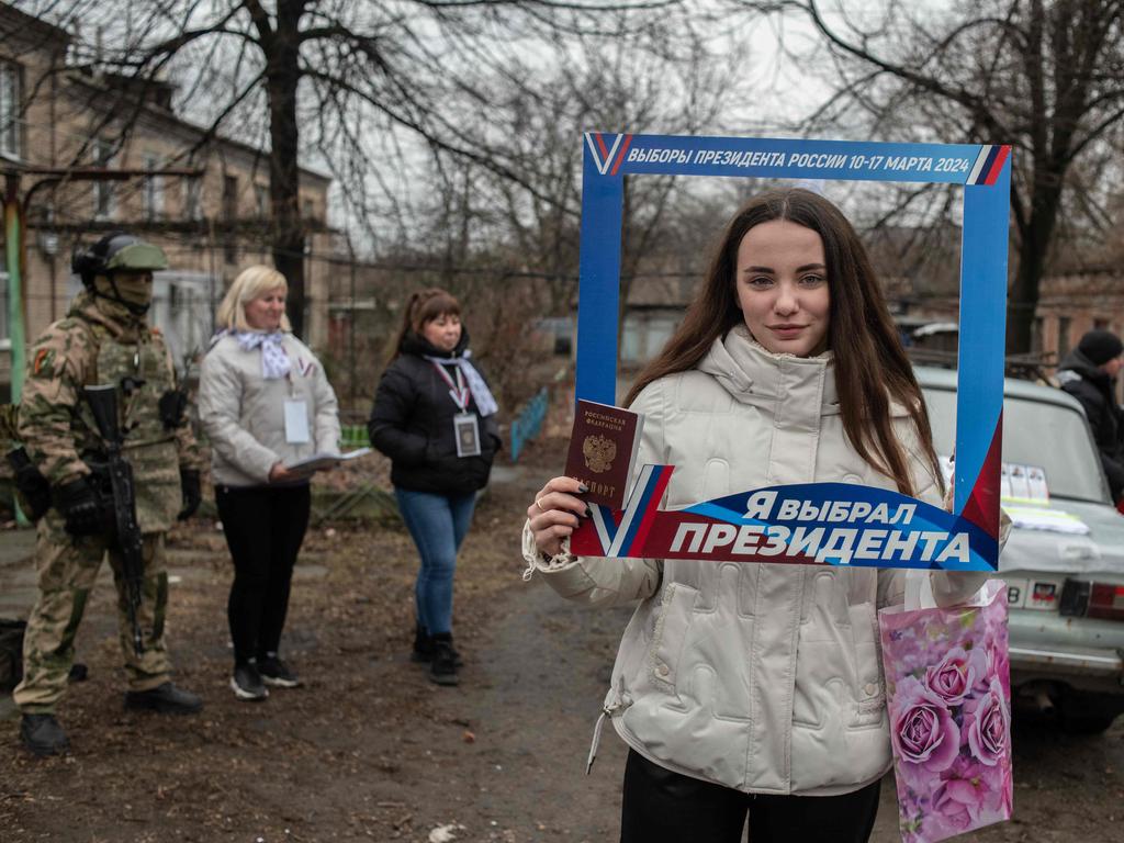 A young woman poses with a frame reading "I chose a president" during Russia's presidential election in Donetsk, Russian-controlled Ukraine. Picture: AFP