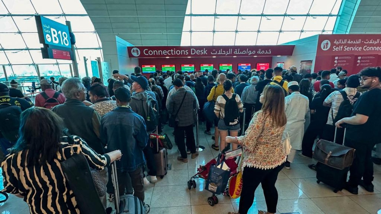 Passengers queue at a flight connection desk at the Dubai International Airport after scores of flights were cancelled or delayed. Picture: AFP