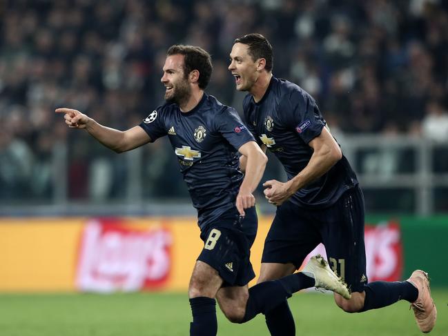 Manchester United's Spanish midfielder Juan Mata (L) celebrates with Manchester United's Serbian midfielder Nemanja Matic after scoring a free kick, equalizing during the UEFA Champions League group H football match Juventus vs Manchester United at the Allianz stadium in Turin on November 7, 2018. (Photo by Isabella BONOTTO / AFP)