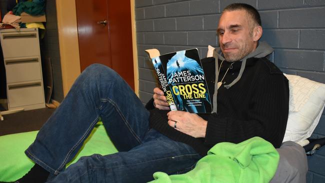 Glenn, saved from the streets in Vermont, kicks back with his book at Winter Shelter. Picture: KIEL EGGING.