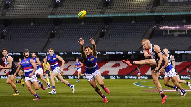 St Kilda’s Dan Hannebery kicks ahead against Western Bulldogs at Marvel Stadium on Sunday night. Picture: AAP