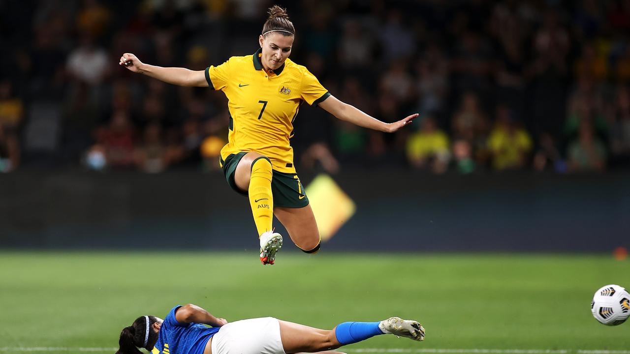 Steph Catley of the Matlidas is tackled in the match against Brazil.