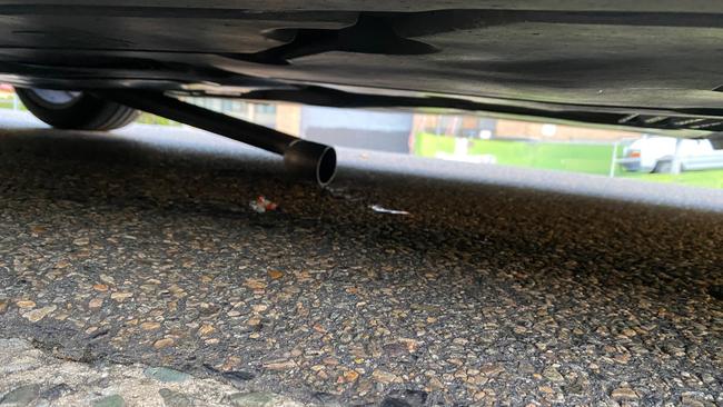 The other part of her exhaust was left hanging under her car after it had been cut. Picture: supplied