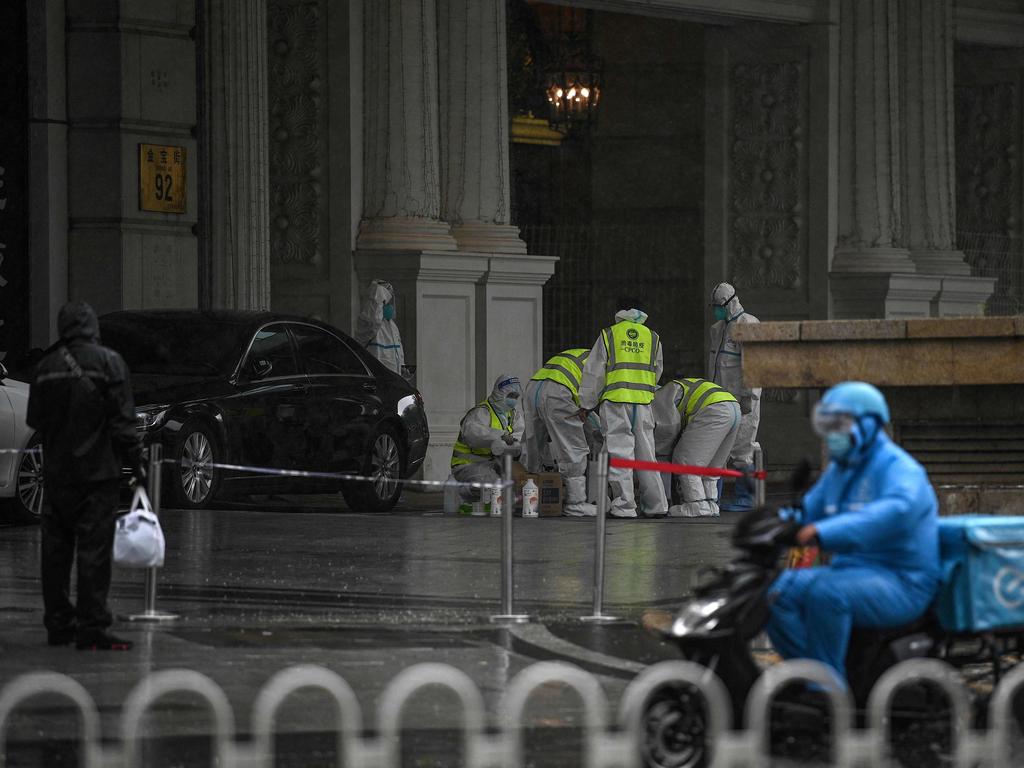 Health workers in Beijing after China reported virus outbreaks in three cities, including the capital. Picture: AFP