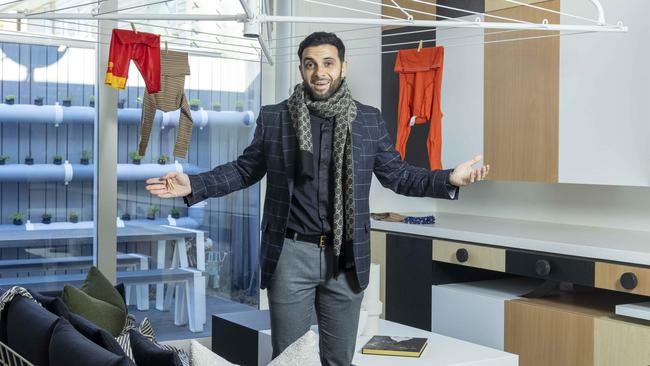 Bizarre Yarraville home for sale. Estate agent Huss Saad  inside the home with the functioning Hills Hoist chandelier.Picture by Wayne Taylor 6th July 2022