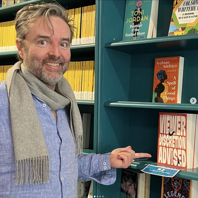 Angus Stevens with a copy of his book he wrote during the pandemic lockdowns, Viewer Discretion Advised.