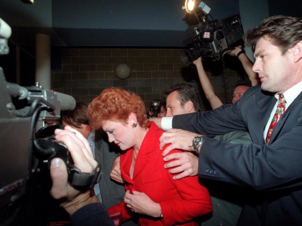 Pauline Hanson is escorted through a crowd of angry protesters into Perth Superdrome ahead of a breakfast speaking engagement. May, 1997.