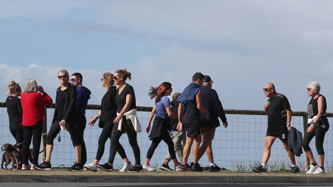 Surfers Paradise wakes up to its first day in lockdown due to the latest CoVid-19 scare. Crowds walking around Narrowneck without masks. Photo: Glenn Hampson