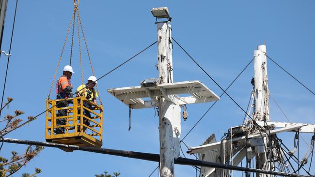 Workers dismantling the masts in March. Picture: Dean Martin