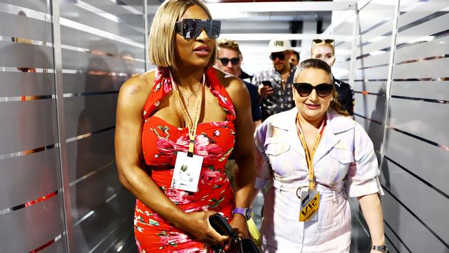 Serena Williams walks through the Red Bull Racing garage