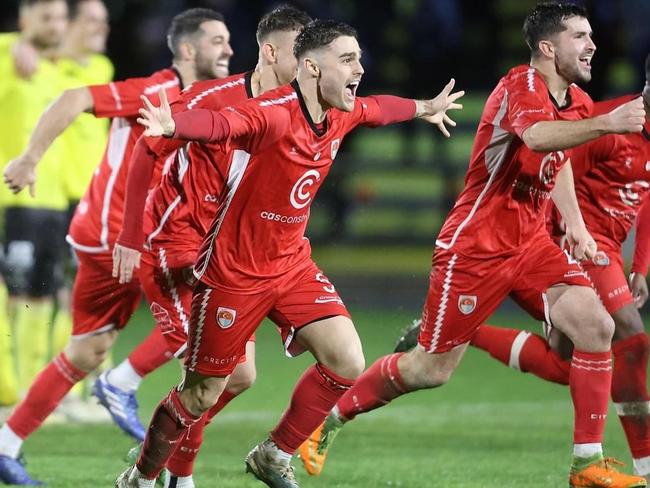 Hume City players celebrate their penalty shootout win. Picture: Teyfik Baser