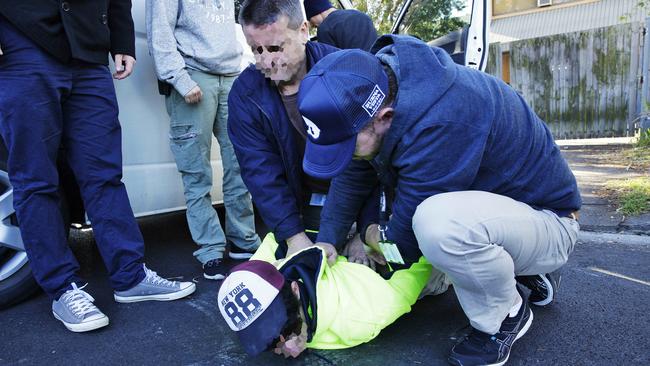 Police arrest a man connected with a large cannabis set-up in Brookvale. Picture: Braden Fastier