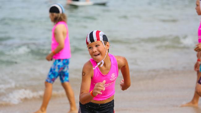 A competitor running up the beach.