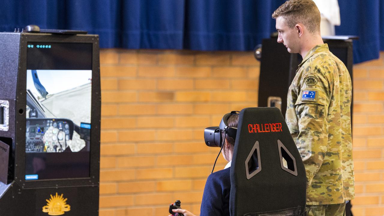 Lieutenant Reilly Scot of Aviation STEM Motivation Program at Toowoomba Anglican School as students use the VR helicopter flight simulators. Picture: Kevin Farmer