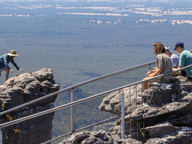 A man climbs the steep cliff face at Pinnacle Lookout. Picture: Jason Edwards