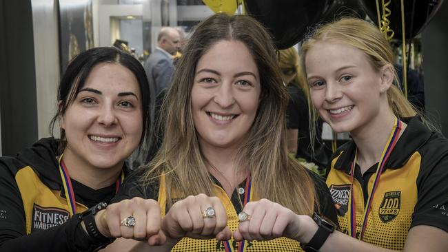 L-R Jess Bates, Glenelg captain Ellie Kellock, and Brooke Tonon celebrate their 2021 premiership. Picture: Supplied