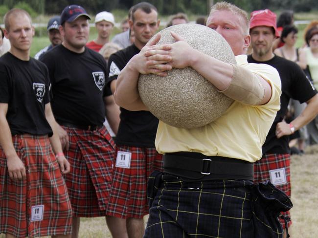 A ‘Highlander’ competes in the Lifting the Stone at Highland games made up of traditional Scottish sports accompanied by Scottish music. Picture: AFP