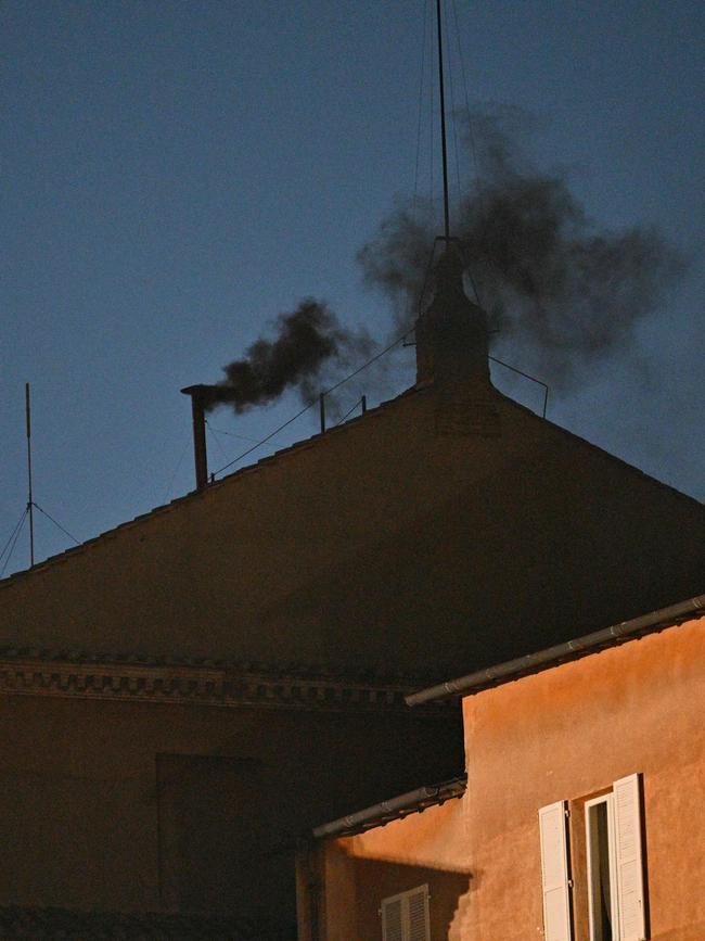 Black smoke rises from the chimney of the Sistine Chapel. Picture: AFP