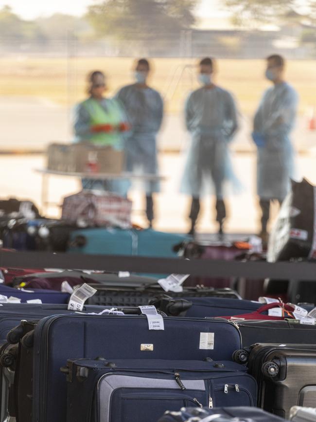 Expatriates collect luggage from their Delhi flight. Picture: ADF, Supplied