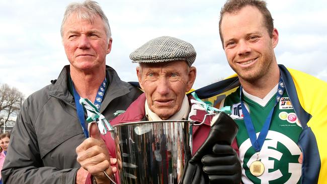 Greensborough coach Robert Hyde celebrates Greensborough’s 2014 premiership with his father and son. Picture: Mark Dadswell