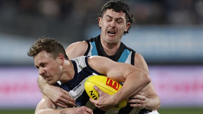 Darcy Byrne-Jones tackles Geelong’s Mitch Duncan. Picture: Darrian Traynor/AFL Photos/via Getty Images