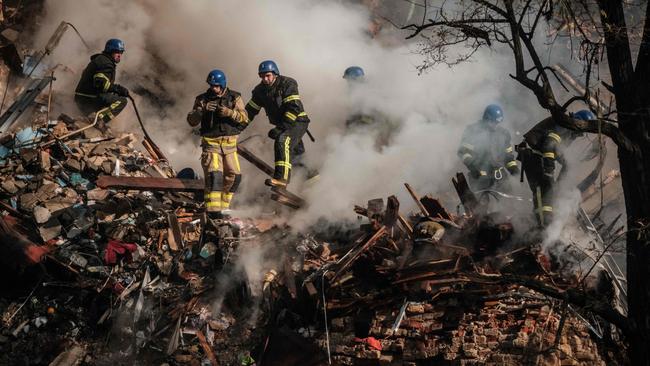 Ukrainian firefighters work on a destroyed building after a drone attack in Kyiv. Picture: AFP.