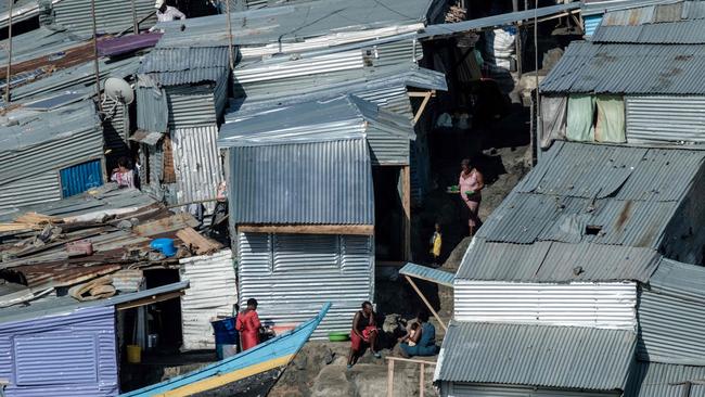 The rounded rocky outcrop is covered in metal shacks and home to roughly 1000 people. Picture: Yasuyoshi Chiba / AFP