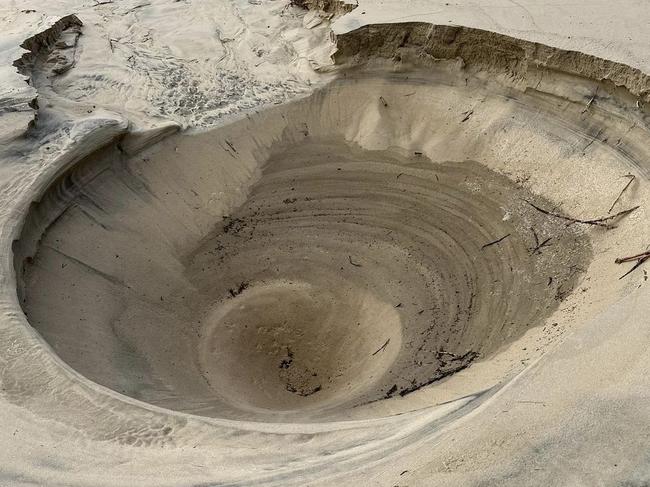 A two metre hole erupted in the middle of Main Beach. Picture: Supplied