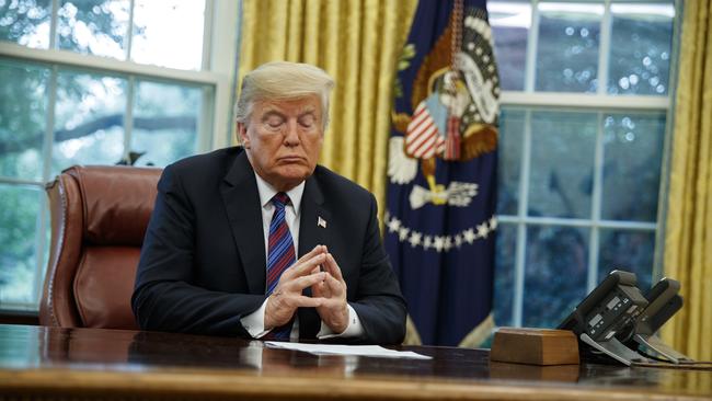Donald Trump on the phone to Mexican President Enrique Pena Nieto yesterday. Picture: AP